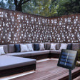 echosari cool white solar curtain lights behind a patio sofa with panel