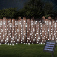 echosari cool white solar curtain lights along a fence with panel