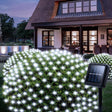 echosari cool white solar net lights on shrubs with panel outside a house
