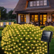 echosari warm solar net lights on shrubs with panel outside a house